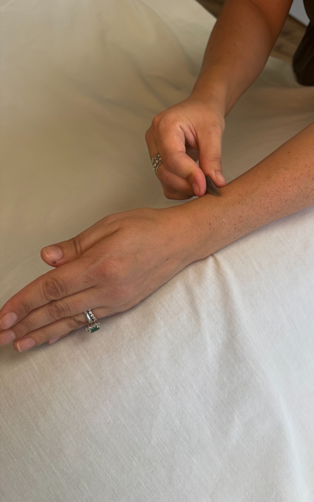 Using smoky quartz to massage Lung 7 near the wrist