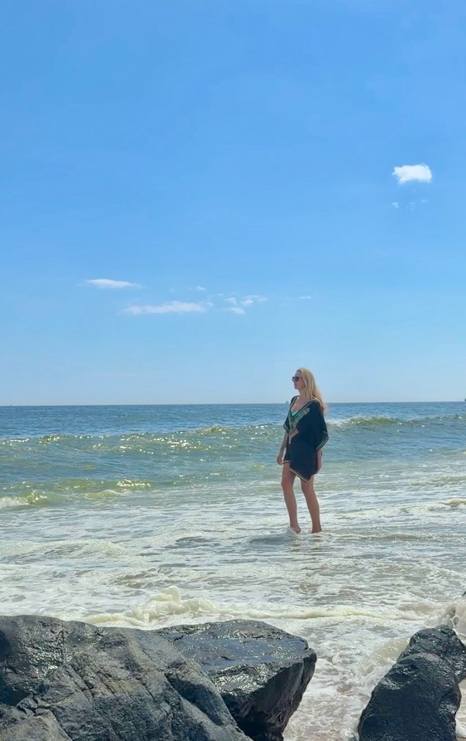 Megan grounding barefoot in the ocean at the Jersey Shore