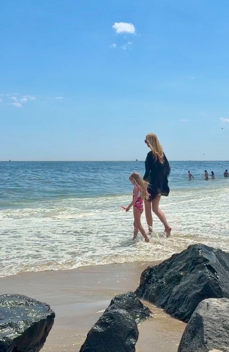 Walking barefoot through the shoreline with a child
